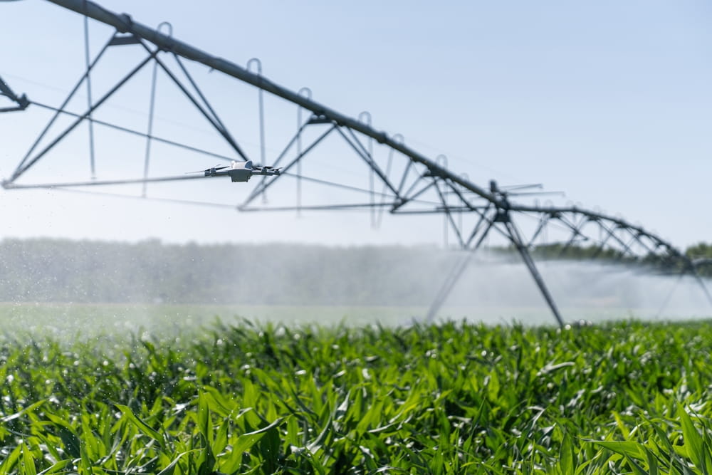 Drone controls pivot irrigation system on an agricultural field